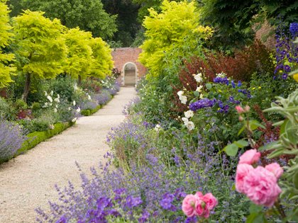 Peter Coats border and archway leading to the grounds beyond
